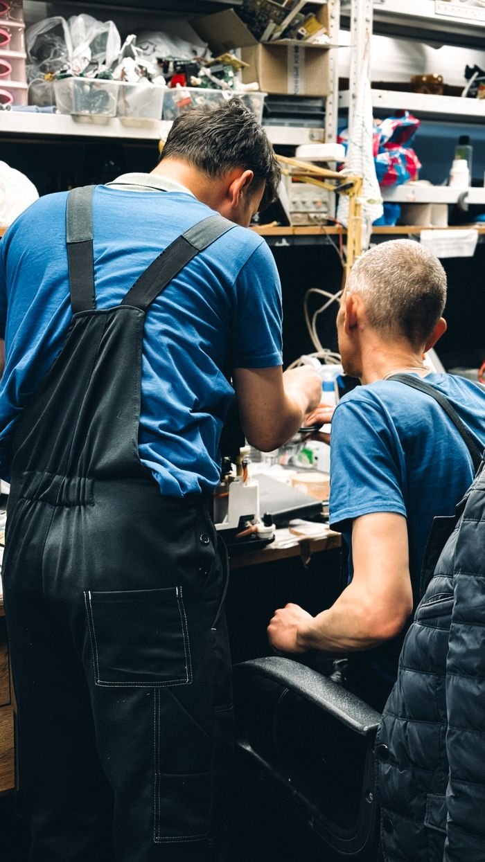 Crafting Captivating Headlines: Your awesome post title goes here Two engineers focused on maintenance work in a cluttered workshop, teamwork, expertise.