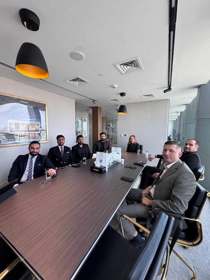 The Art of Drawing Readers In: Your attractive post title goes here Business professionals in a formal meeting at a modern conference room.